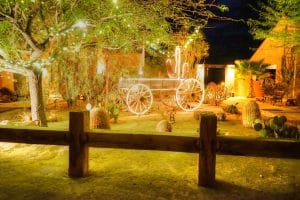 Dude Ranch at night with farm wagon